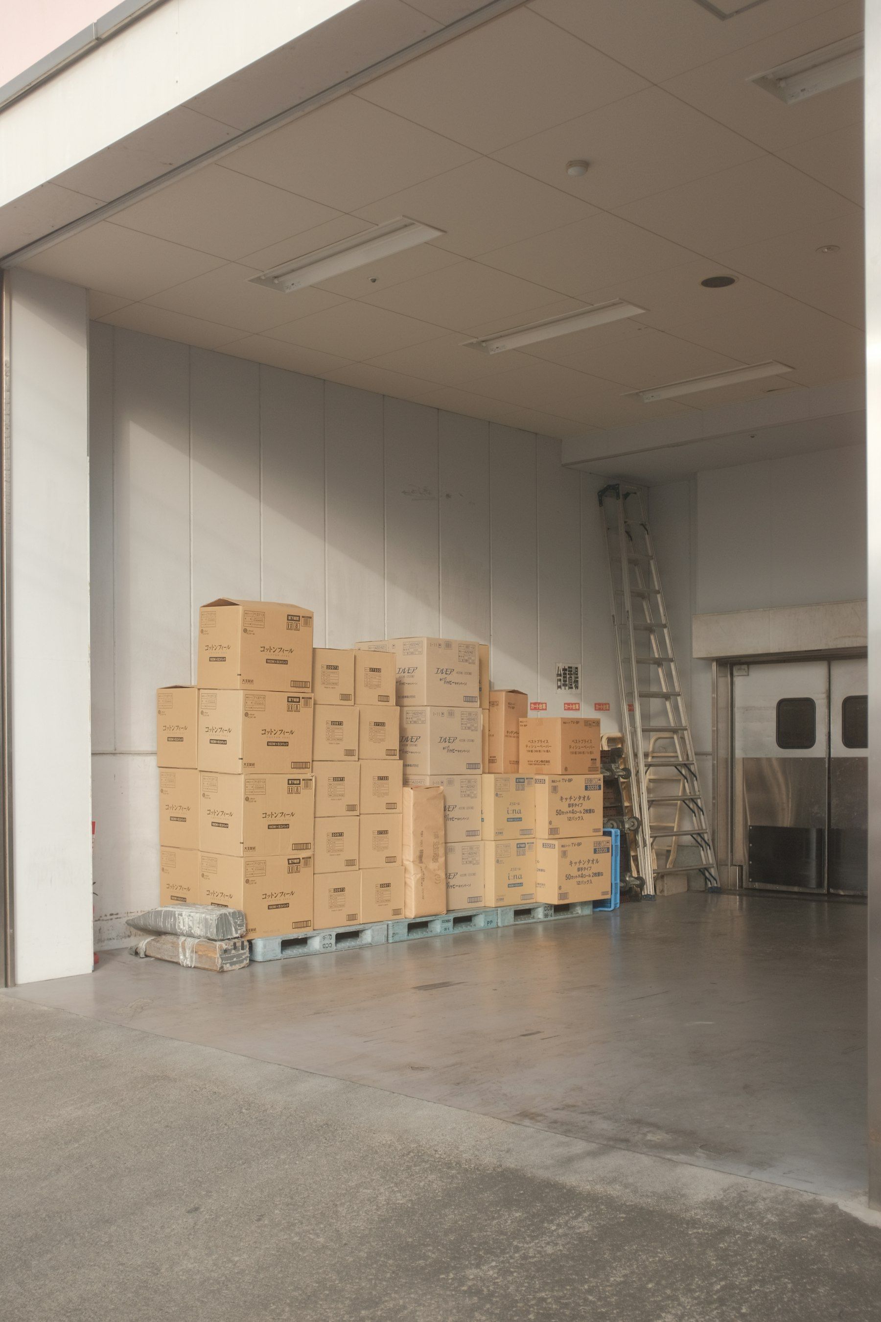 Cardboard boxes stacked on a pallet in a clean storage room