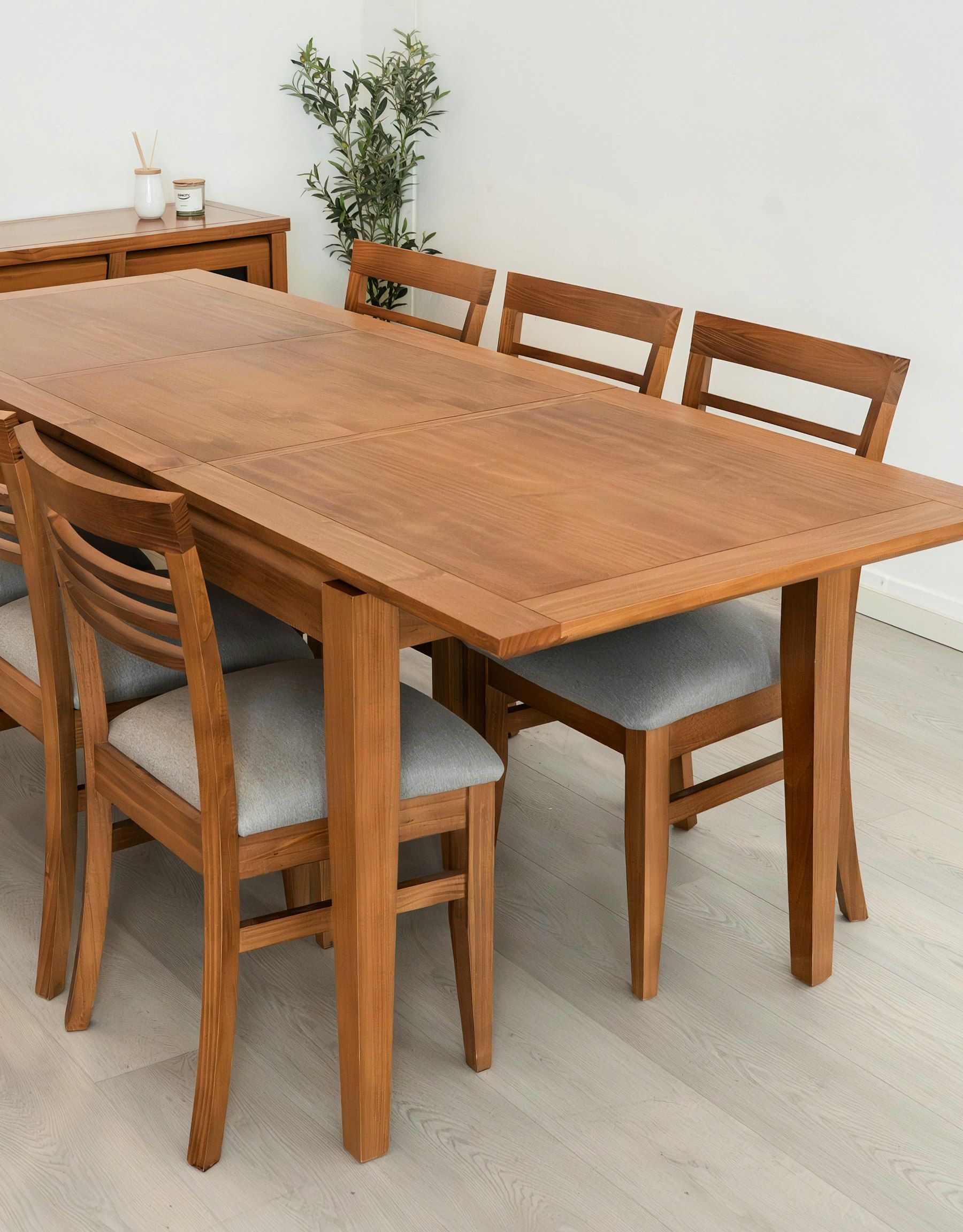 Wooden dining table with upholstered chairs