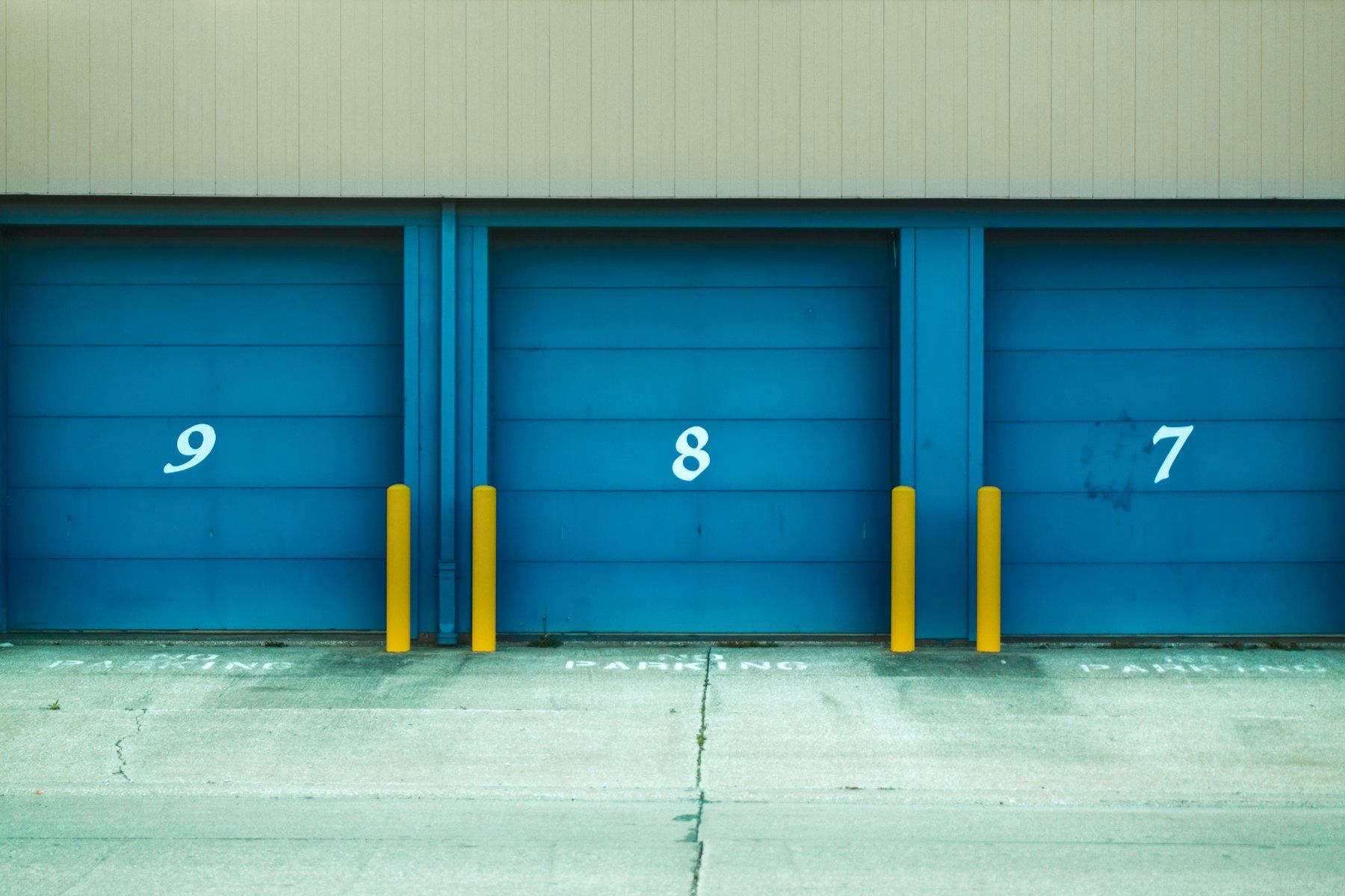Numbered blue roller doors of storage units