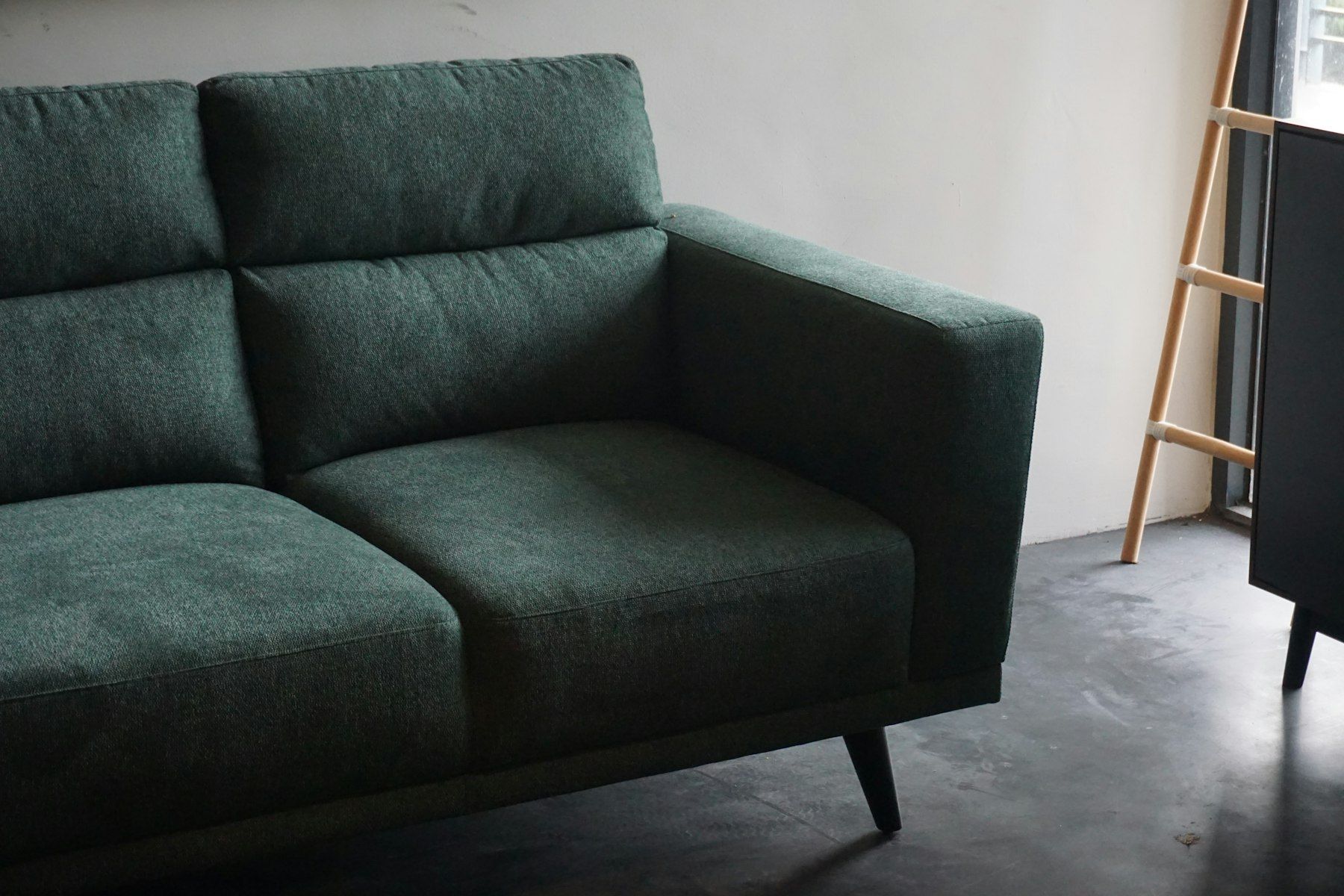 Green fabric sofa in a bright room