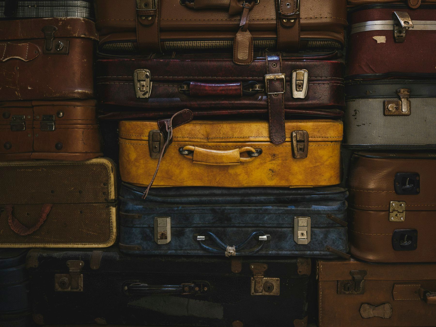 Stack of leather suitcases in different colours