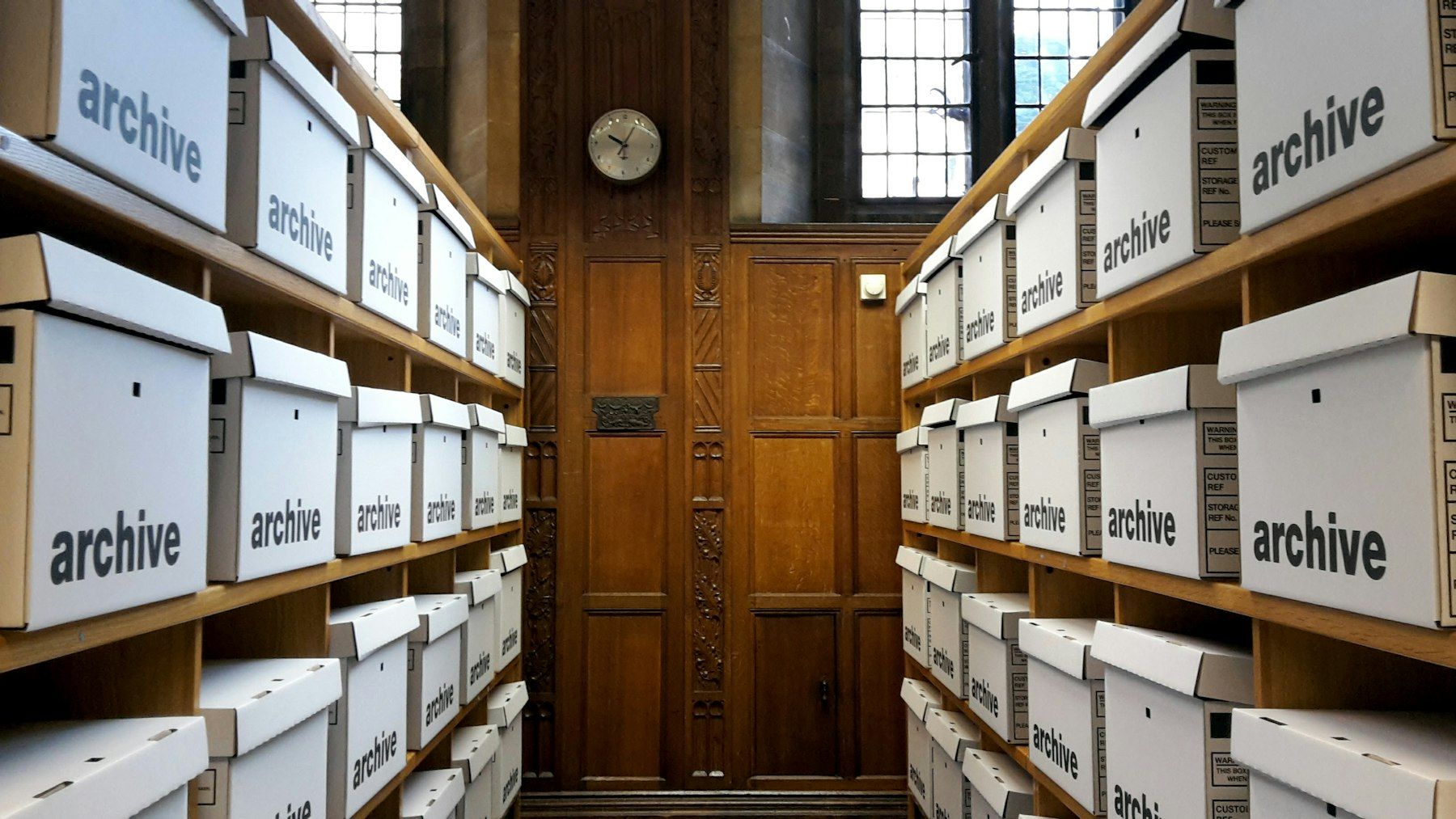 Shelves of labelled white archive boxes