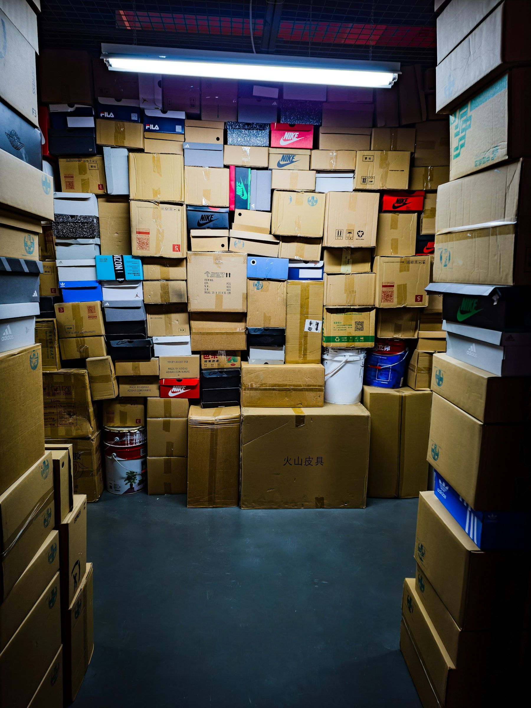 Room filled with stacked cardboard boxes