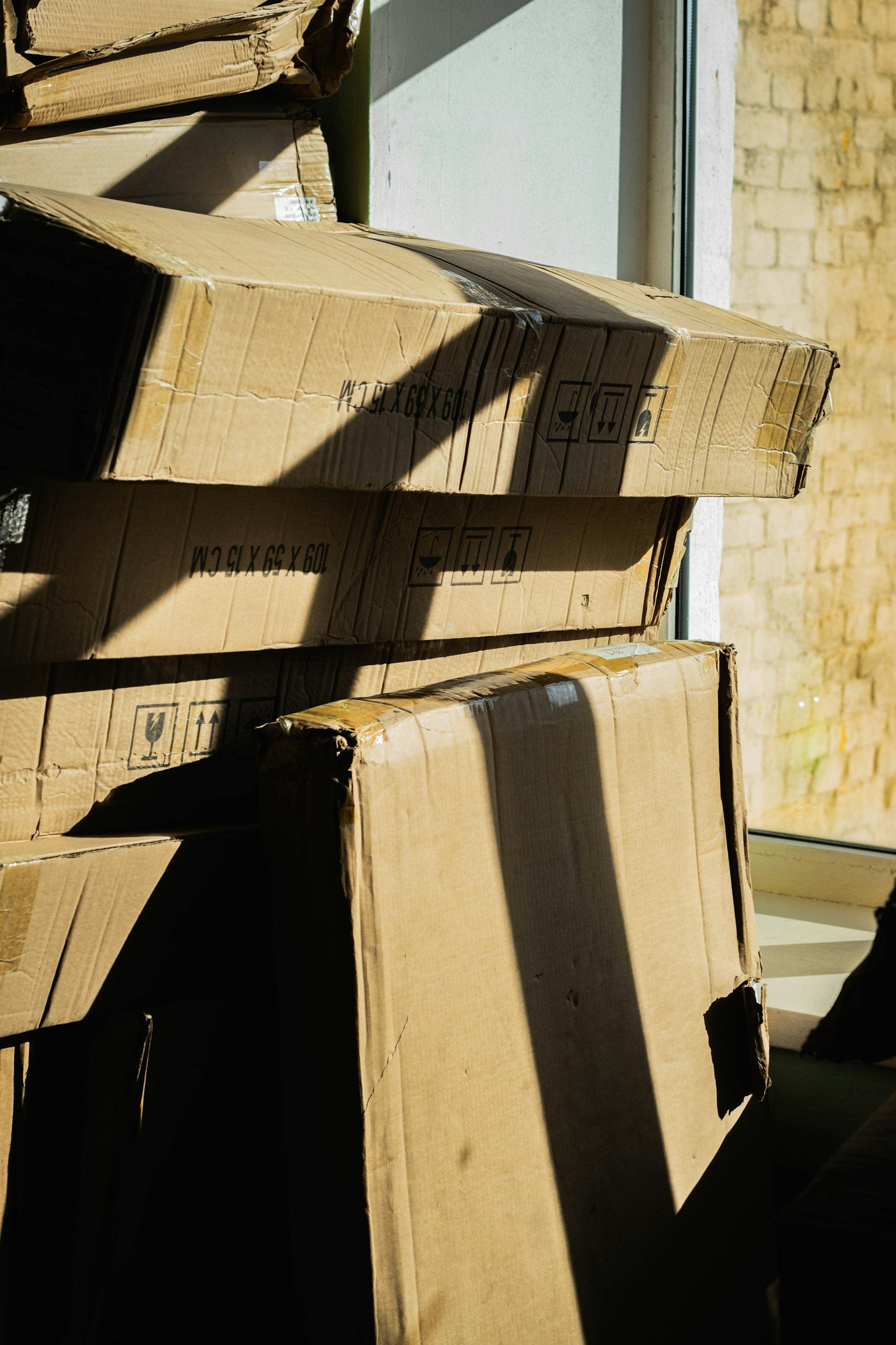 Stack of cardboard boxes by a window