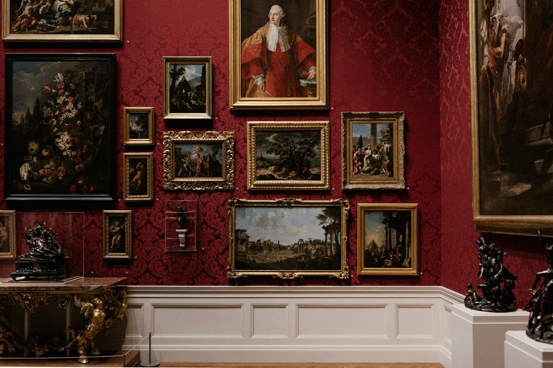 Framed paintings hung on a gallery wall