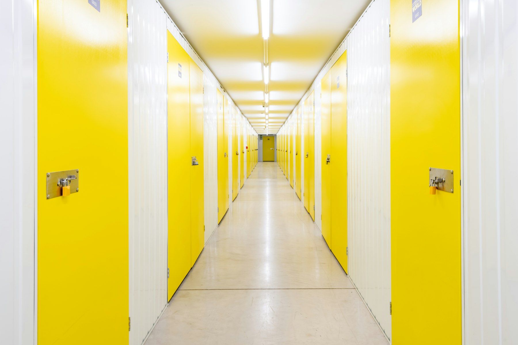 Corridor of storage units with yellow doors